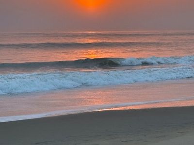 A calm outdoor scene, like a park or beach at sunrise, evoking peace.